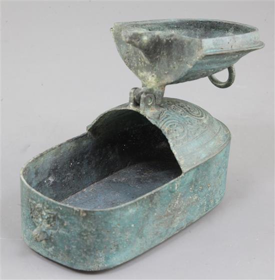 A Chinese archaic bronze portable lamp, Han dynasty, 2nd century B.C.- 2nd century A.D. 15cm long, hole to cover